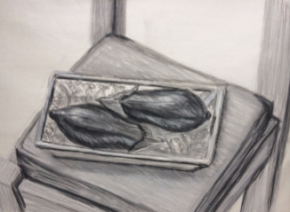aubergines on a patterned plate in compressed charcoal